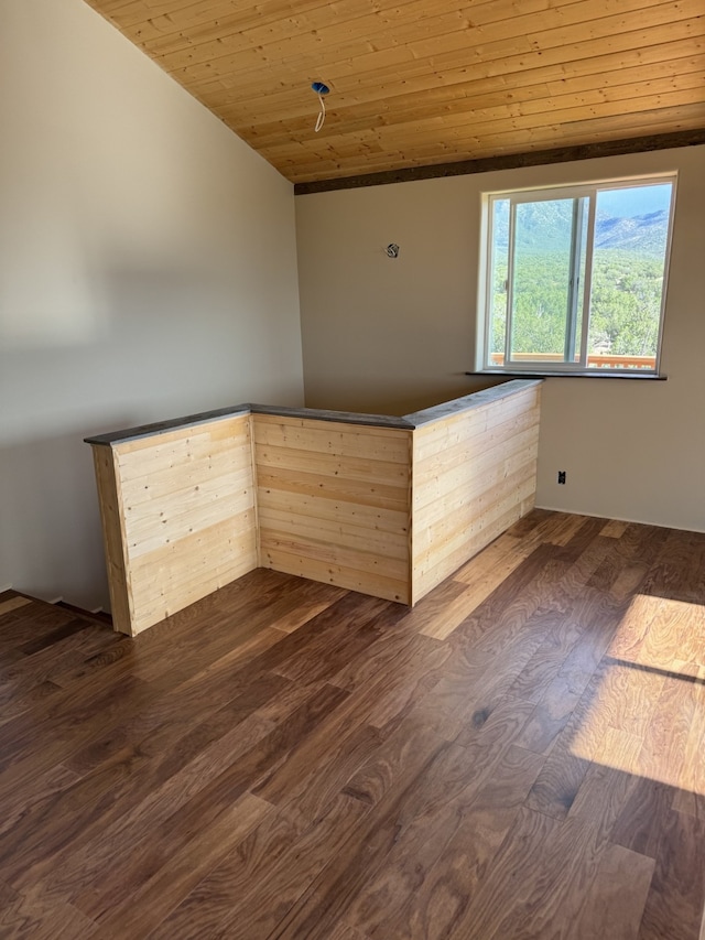 unfurnished room with dark hardwood / wood-style flooring, vaulted ceiling, and wood ceiling