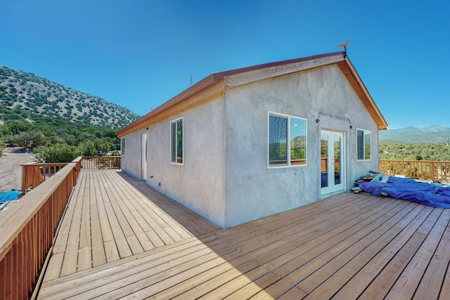 wooden deck featuring a mountain view and french doors