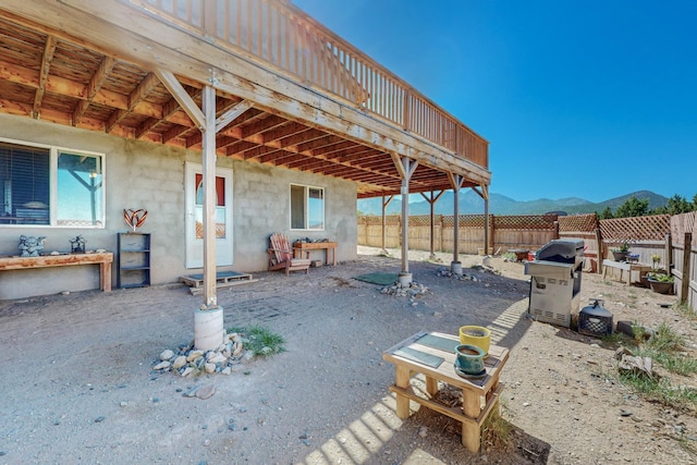 view of patio with a mountain view and a grill