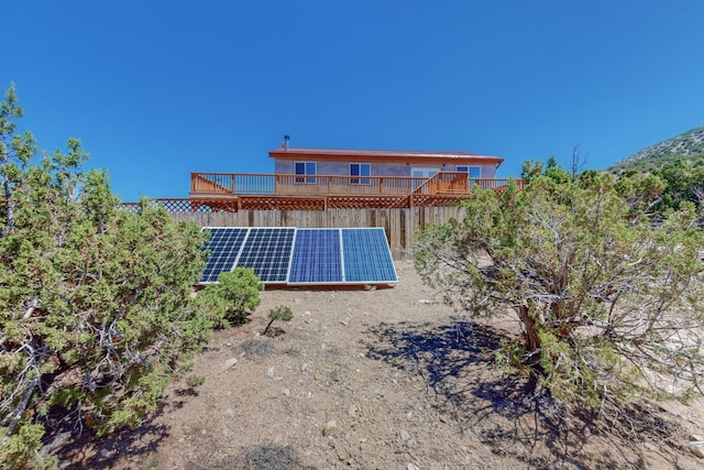 rear view of property with solar panels