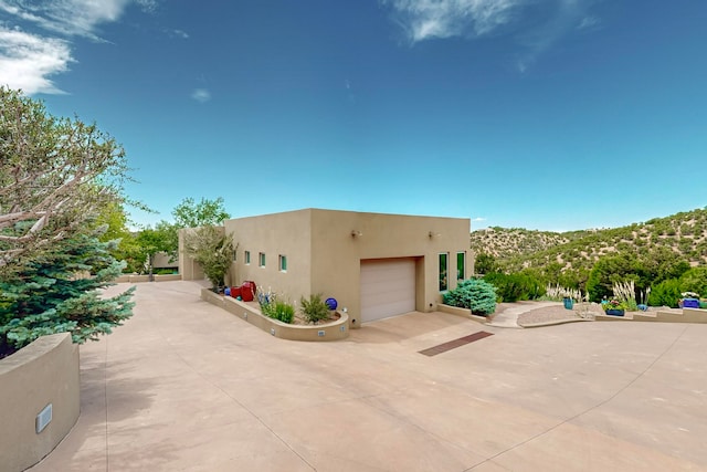 view of front of house featuring a mountain view and a garage