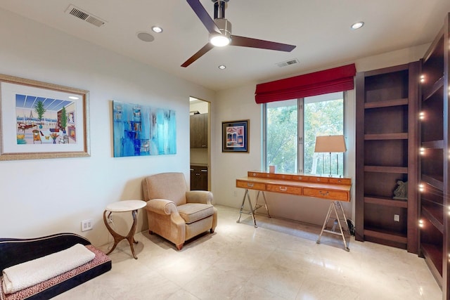 living area featuring ceiling fan