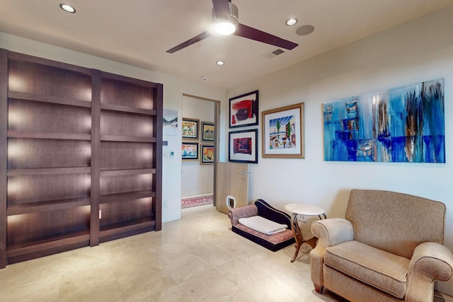 living area featuring ceiling fan