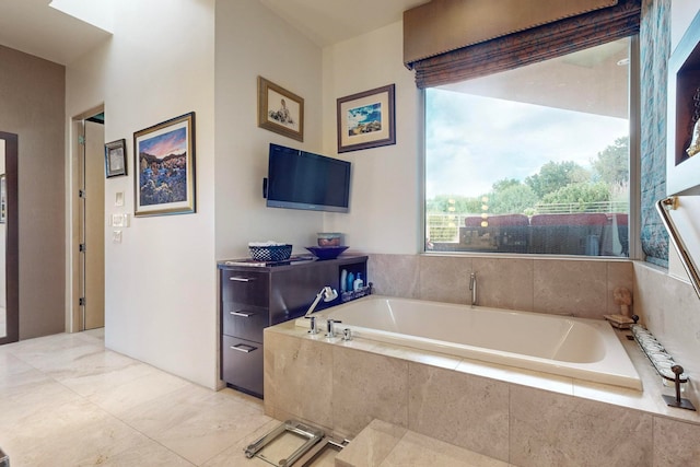 bathroom with a relaxing tiled tub