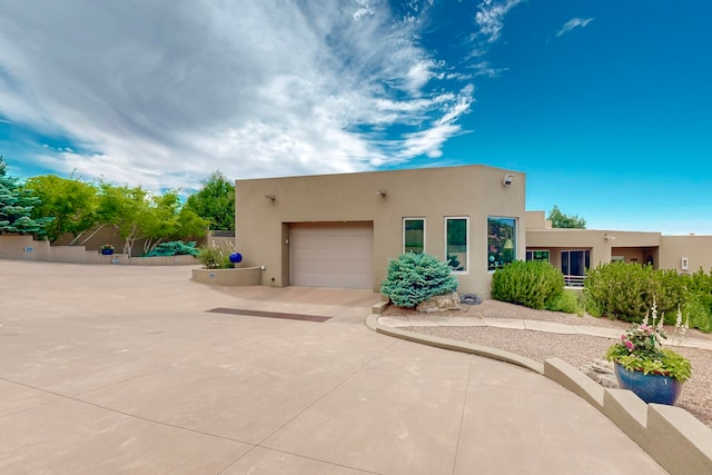 pueblo-style home with a garage