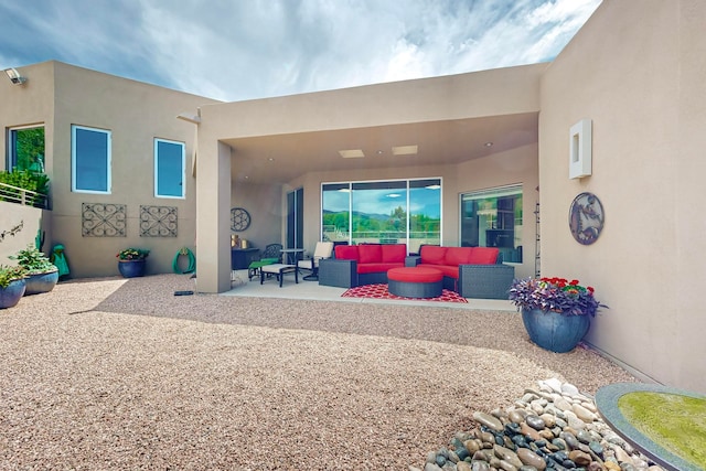 rear view of house with a patio area and an outdoor living space