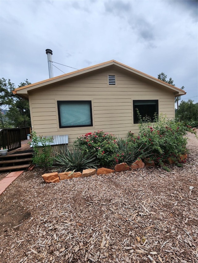 view of side of home featuring a wooden deck