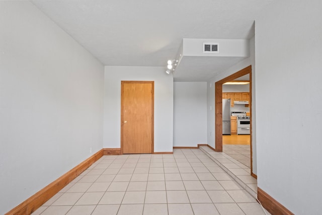 spare room with light tile flooring