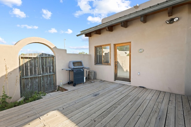 wooden terrace with a grill