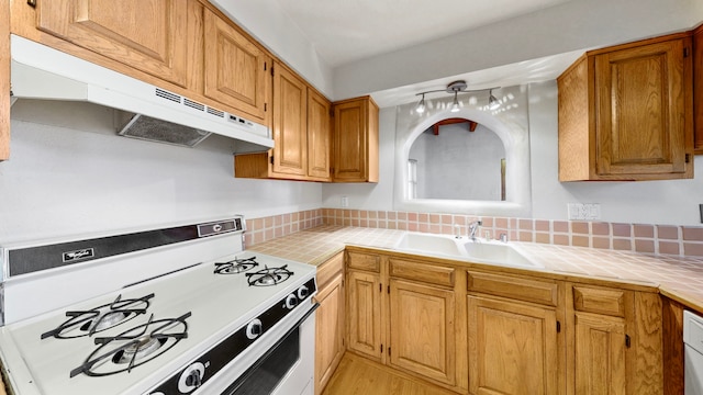 kitchen with sink, white stove, and light wood-type flooring