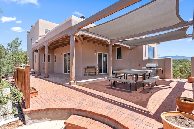 view of patio / terrace featuring area for grilling and a mountain view