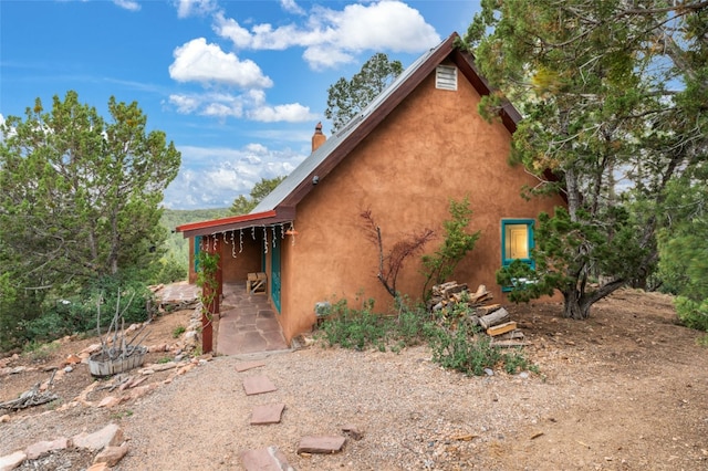 view of side of property featuring a patio area