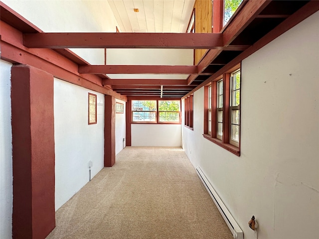 corridor with beamed ceiling, baseboard heating, and carpet