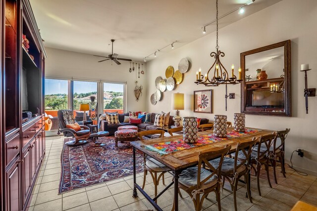 tiled dining room featuring ceiling fan with notable chandelier and track lighting