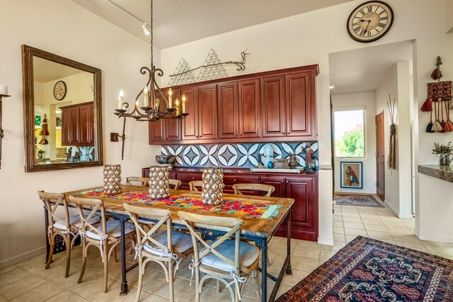 dining room with light tile patterned flooring and an inviting chandelier