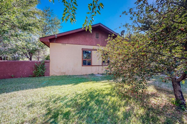 view of home's exterior with a lawn