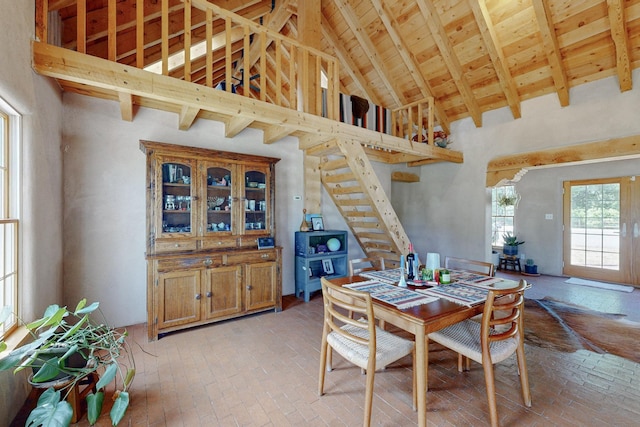 dining area with beamed ceiling, wooden ceiling, and high vaulted ceiling