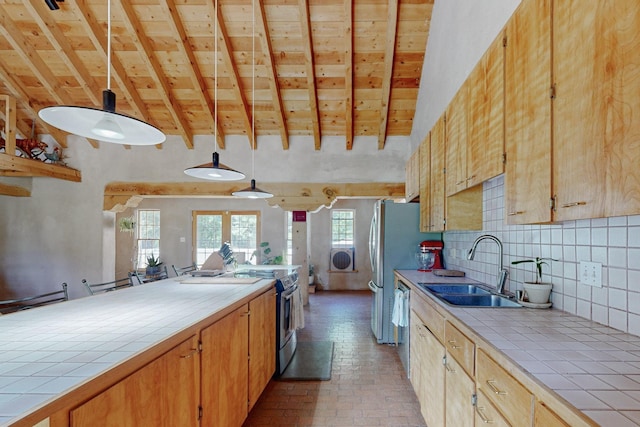 kitchen featuring tile countertops, decorative backsplash, and decorative light fixtures