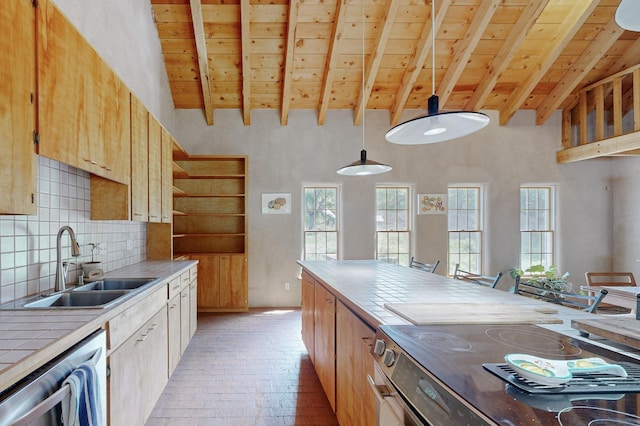 kitchen featuring stainless steel dishwasher, decorative light fixtures, lofted ceiling with beams, and sink