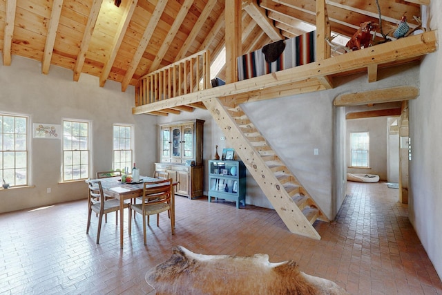 dining room with beamed ceiling, wooden ceiling, and high vaulted ceiling