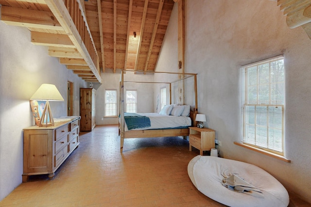 bedroom with beamed ceiling, wood ceiling, and multiple windows