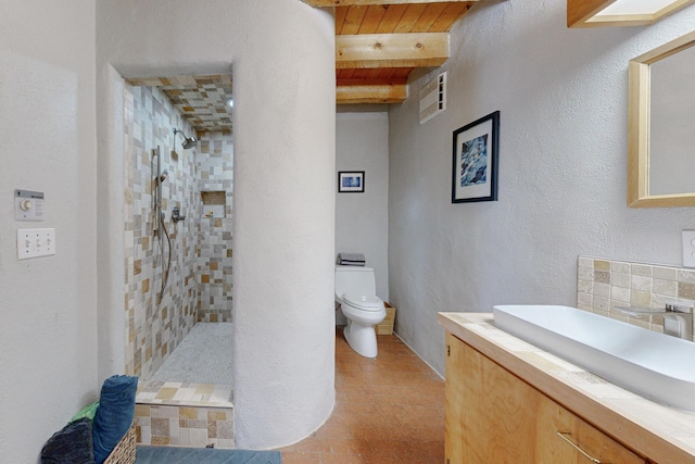 bathroom featuring beam ceiling, backsplash, toilet, tiled shower, and wood ceiling