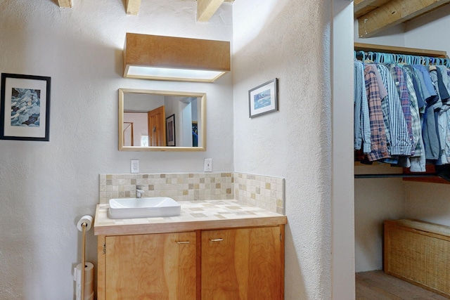 bathroom with backsplash and vanity