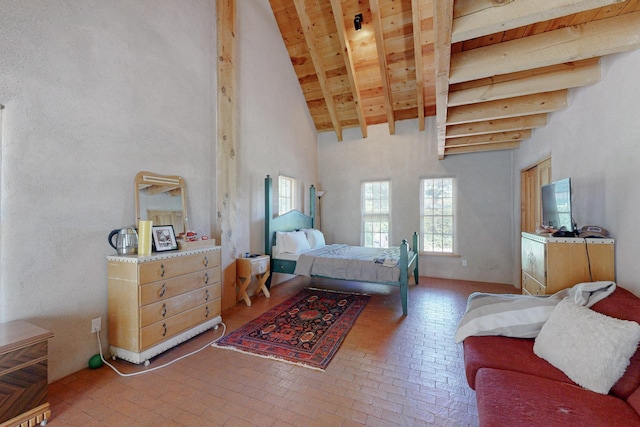 bedroom featuring beam ceiling and high vaulted ceiling