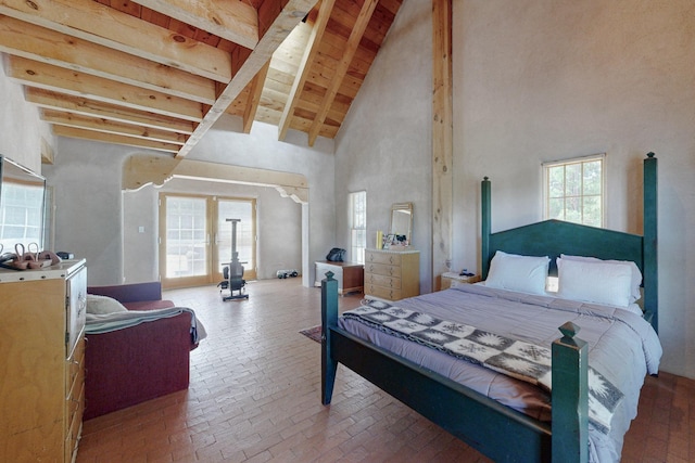 bedroom with beamed ceiling and a high ceiling