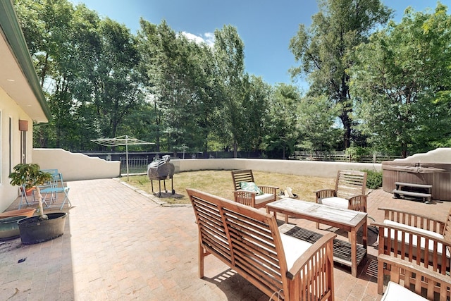 view of patio / terrace with a hot tub