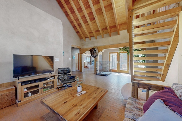 living room featuring beamed ceiling, high vaulted ceiling, and wood ceiling