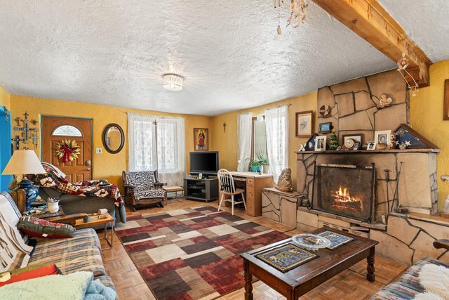 living area featuring a textured ceiling and a fireplace