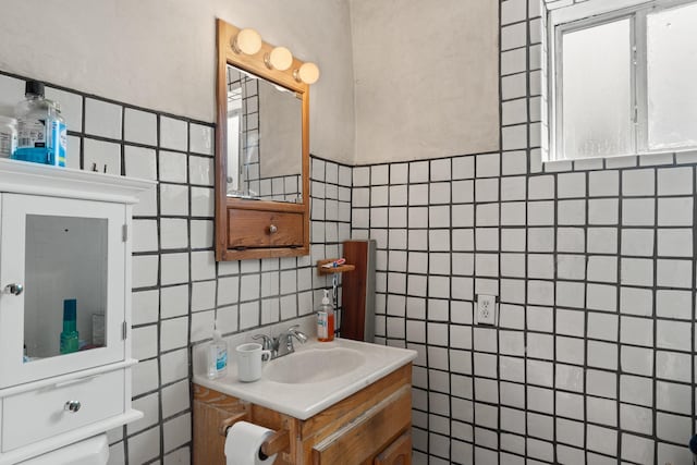 half bath with tile walls and vanity