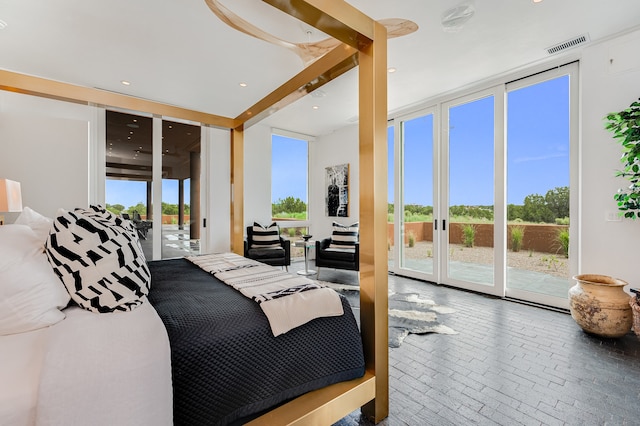 bedroom with access to exterior and floor to ceiling windows