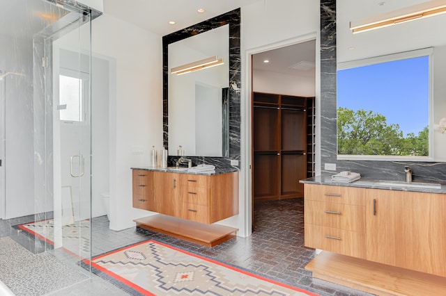 bathroom featuring vanity, a wealth of natural light, decorative backsplash, and toilet