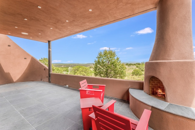 view of patio with an outdoor fireplace