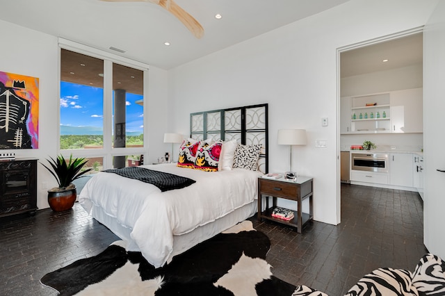 bedroom with dark hardwood / wood-style flooring and ceiling fan