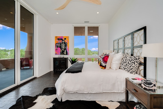 bedroom featuring dark hardwood / wood-style floors, ceiling fan, and access to exterior