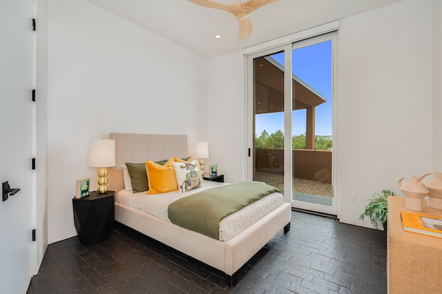 bedroom with dark hardwood / wood-style floors, ceiling fan, and access to exterior