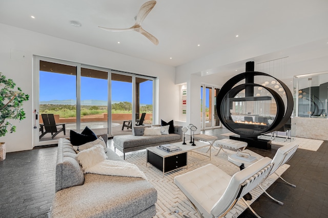 living room featuring hardwood / wood-style flooring and ceiling fan