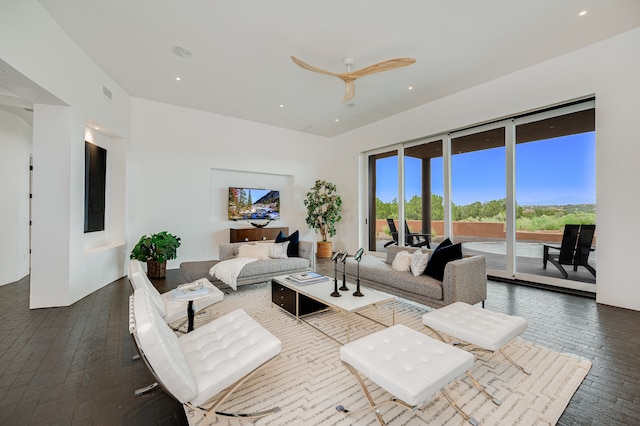 living room featuring dark wood-type flooring and ceiling fan