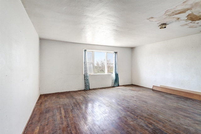 unfurnished room featuring dark hardwood / wood-style floors