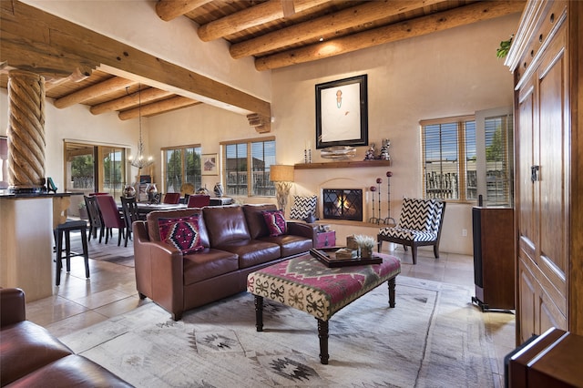 living room with beam ceiling, light tile patterned floors, and a wealth of natural light