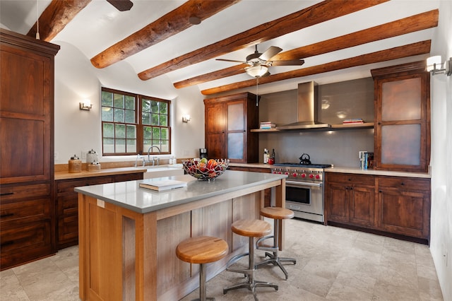 kitchen featuring designer stove, beam ceiling, ceiling fan, sink, and extractor fan