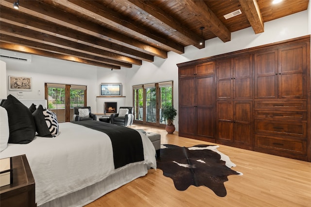 bedroom featuring beamed ceiling, wood ceiling, and light wood-type flooring