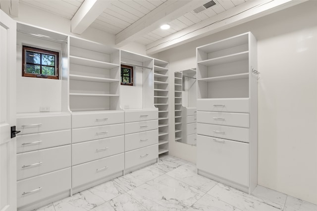 bedroom featuring parquet flooring, beam ceiling, and rail lighting