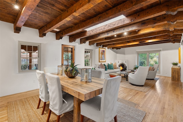 kitchen with a kitchen island, beam ceiling, beverage cooler, range hood, and ceiling fan