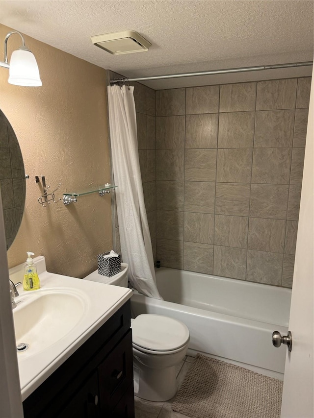 full bath featuring a textured wall, toilet, shower / tub combo with curtain, a textured ceiling, and vanity