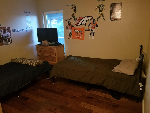 bedroom featuring dark wood-type flooring