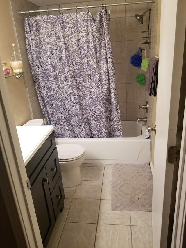 bathroom featuring shower / tub combo, tile patterned flooring, vanity, and toilet